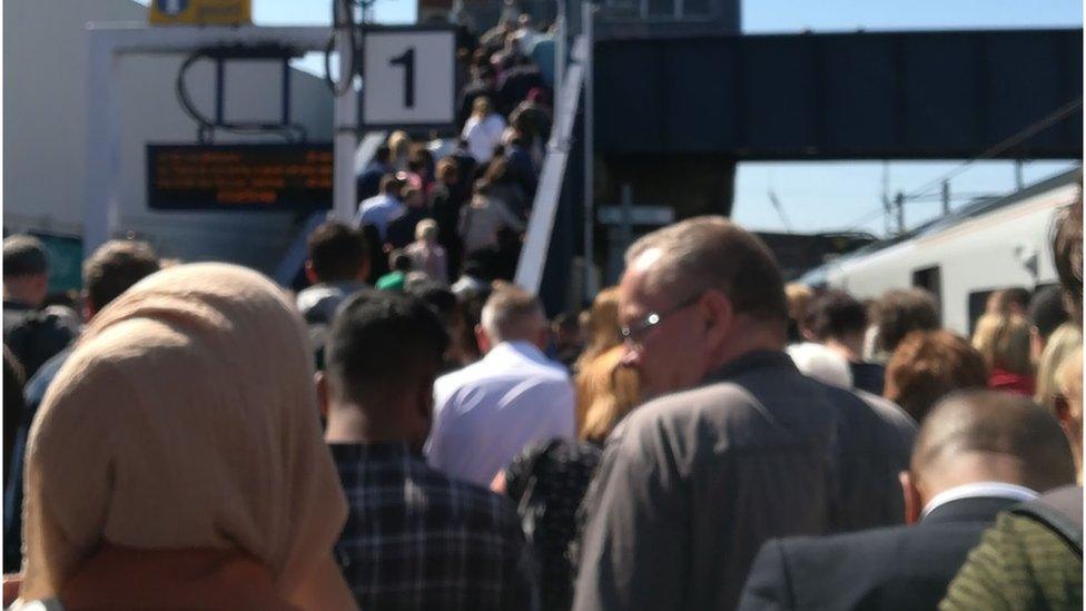 Commuters on a railway station platform