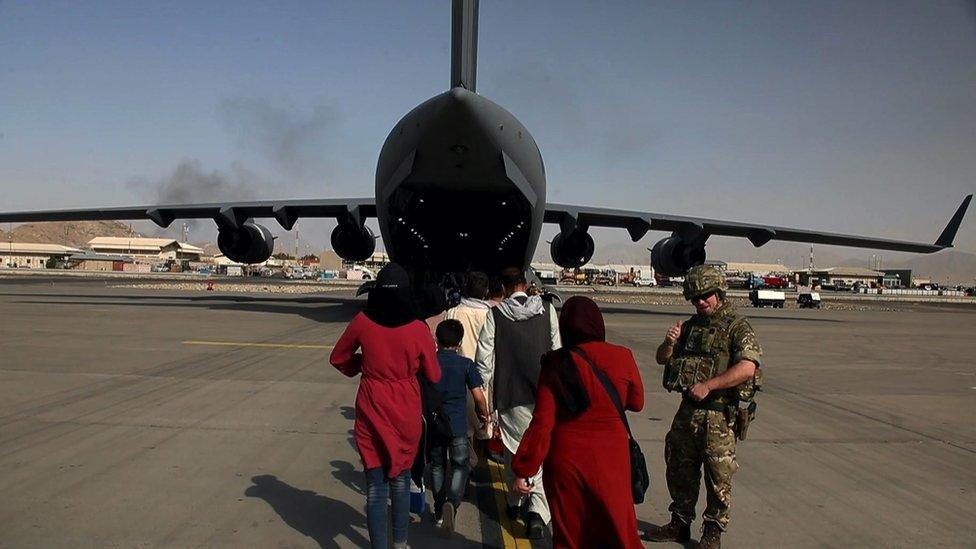 A family boarding a plan to leave Afghanistan