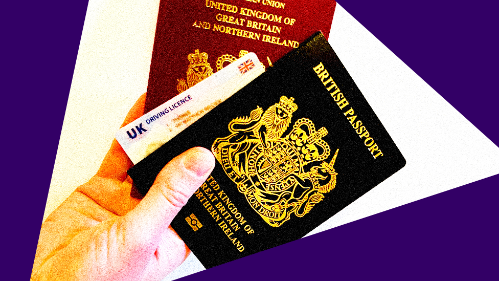 A man holds UK passports and UK drivers licence