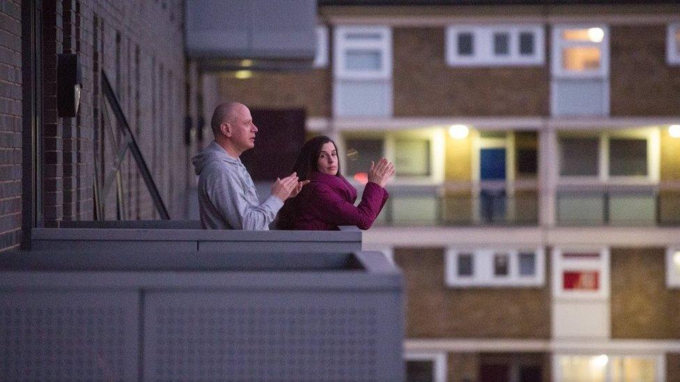 People clap on balcony