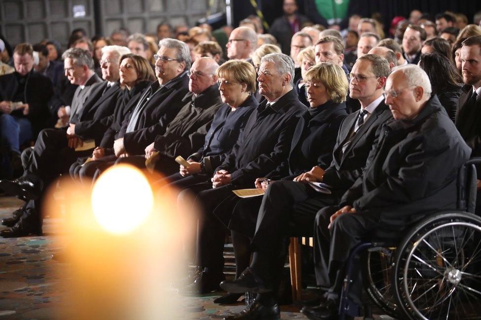 German Chancellor Angela Merkel (centre) and other politicians attend a commemoration in the Kaiser Wilhelm Memorial Church, Berlin, 20 December