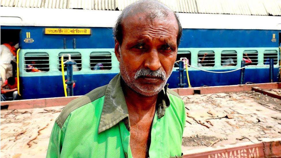 Amar Nath standing in front of a train