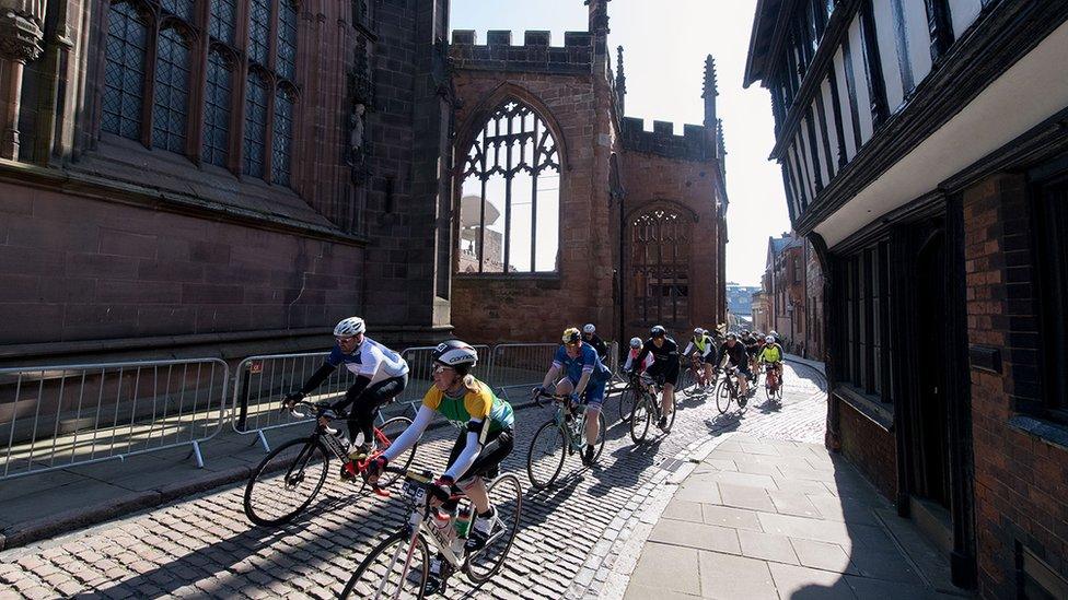 Riders passing Coventry Cathedral