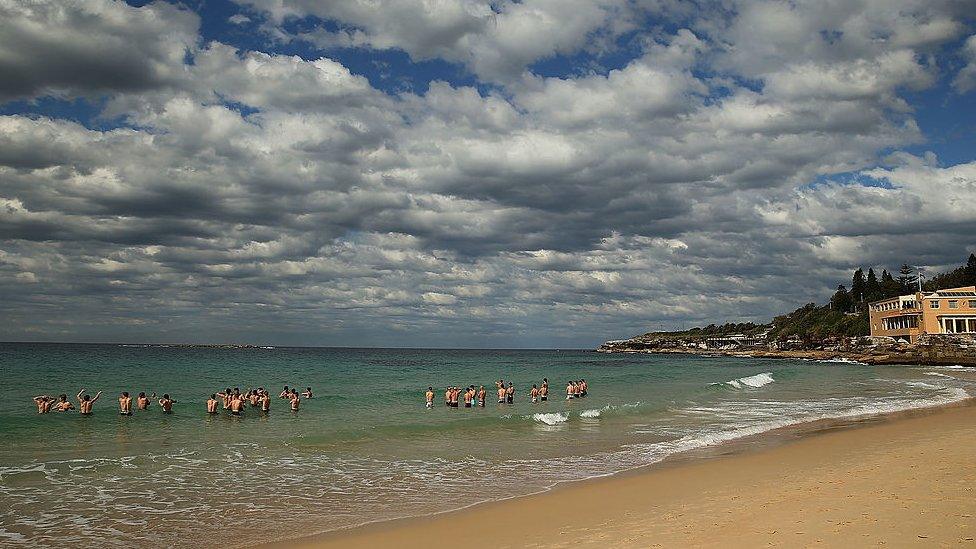 Swans players wade in the ocean during a during a Sydney Swans AFL recovery session at Coogee Beach on August 19, 2013 in Sydney