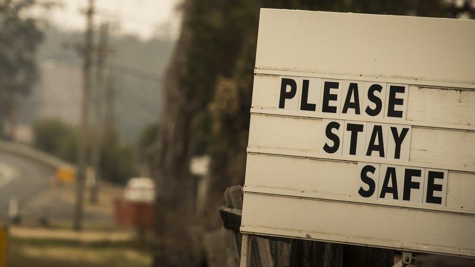 Warning sign on the side of the road in NSW reads: Please stay safe