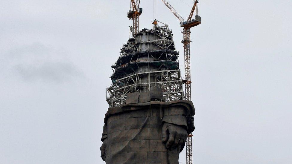 The statue to Sardar Vallabhbhai Patel under construction, with scaffolding and a crane in shot