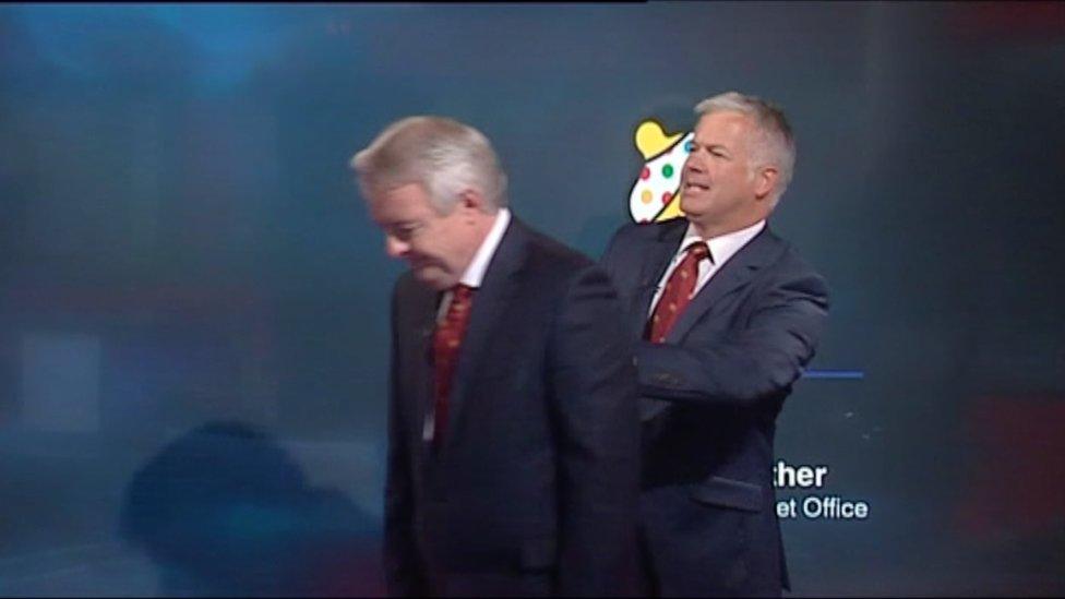 Derek Brockway pushing Carwyn Jones off screen