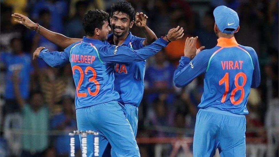 Kuldeep Yadav, Jasprit Bumrah and team"s captain Virat Kohli (L-R)