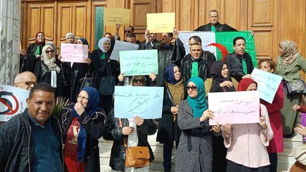 Algerian judges hold placards as they protest against President Bouteflika's bid for a fifth term in power, in the north-eastern city of Annaba on 11 March 2019