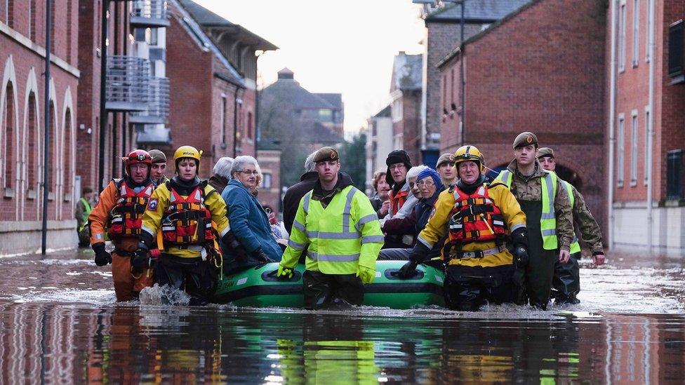 Members of the Army and rescue teams help people in York