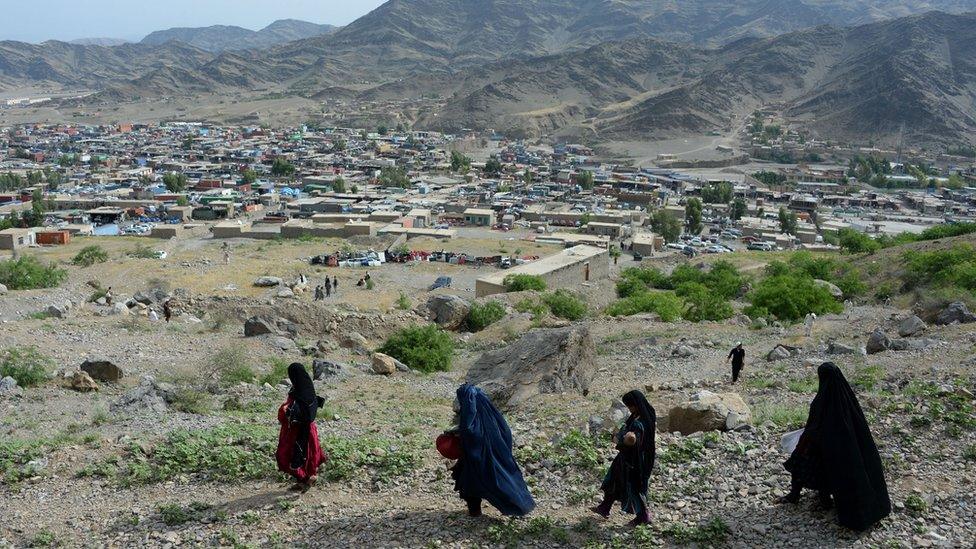 Afghan women cross the Torkham border between Afghanistan and Pakistan through the Shamshad mountains in Nangarhar province on May 12, 2016.