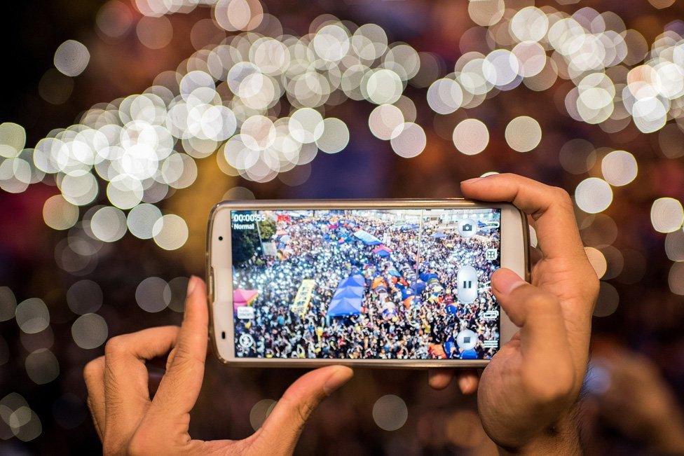 Pro-democracy protester takes a photo of Hong Kong demonstration 2014