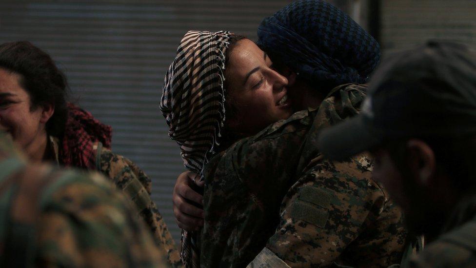 Kurdish members of the Syrian Democratic Forces embrace in Manbij on 10 August 2016