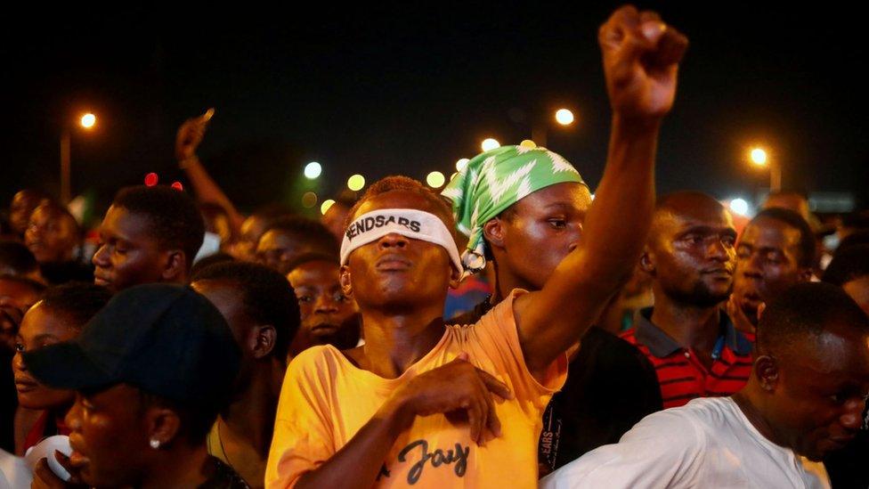 A demonstrator wearing a blindfold with an inscription "End Sars", gestures during protest against alleged police brutality in Lagos, Nigeria October 17, 2020.