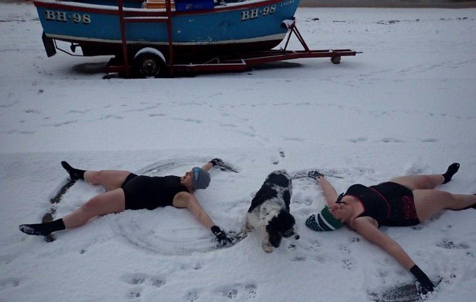 Two swimmers making snow angels in Cullercoats