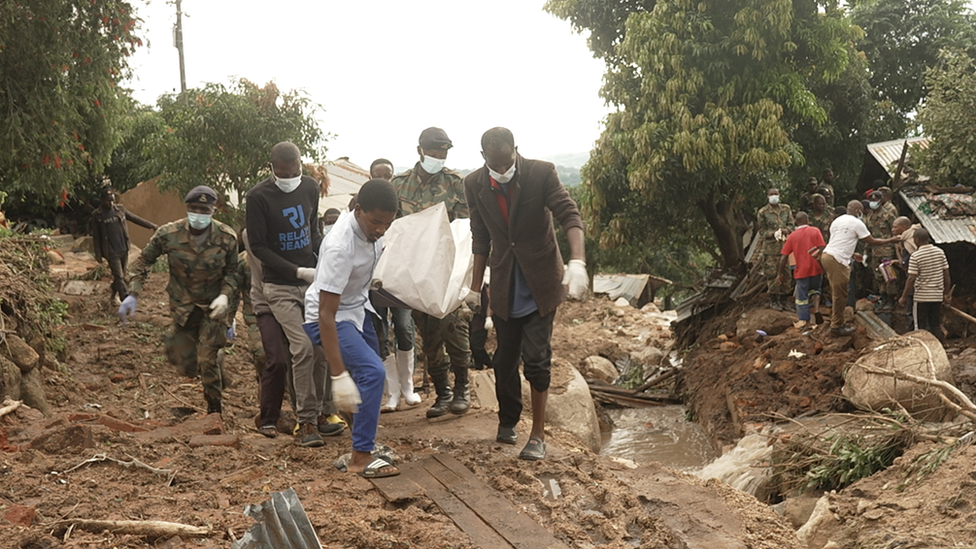 Rescue teams carrying a body