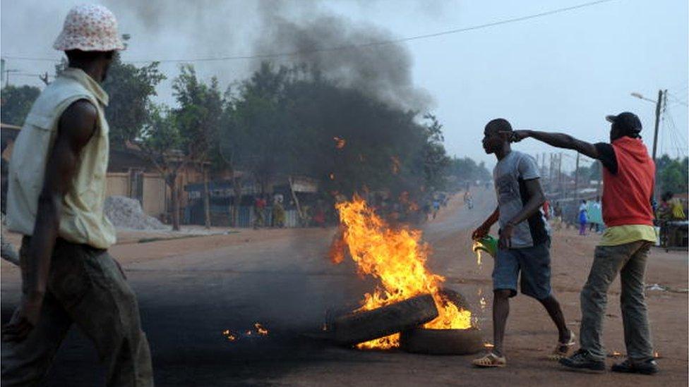 Opposition group members burn tyres on a road in Gagnoa on February 20, 2010.