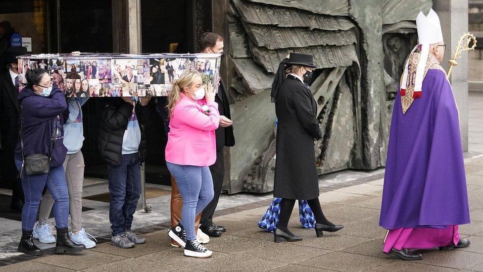 Archbishop leads out coffin after funeral