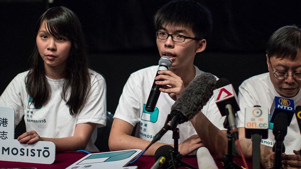 Pro-democracy student leader Joshua Wong (C) speaks as Agnes Chow and Shu Kei listen during a press conference to introduce their new pro-democracy political party called Demosisto in Hong Kong on April 10, 2016, 2016.