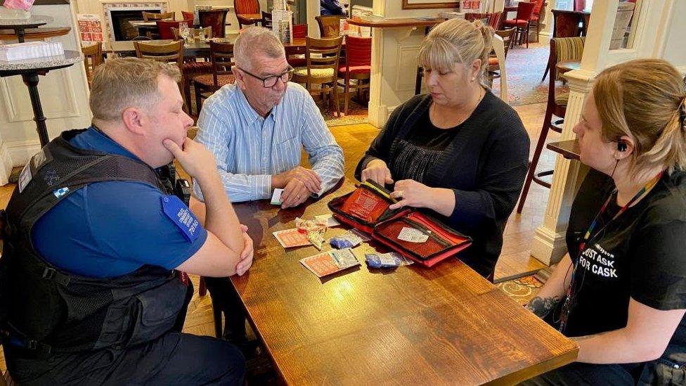 Julie Taylor and PCSO Michael O'Donnell-Smith explaining to pub staff how to use the bleed kits