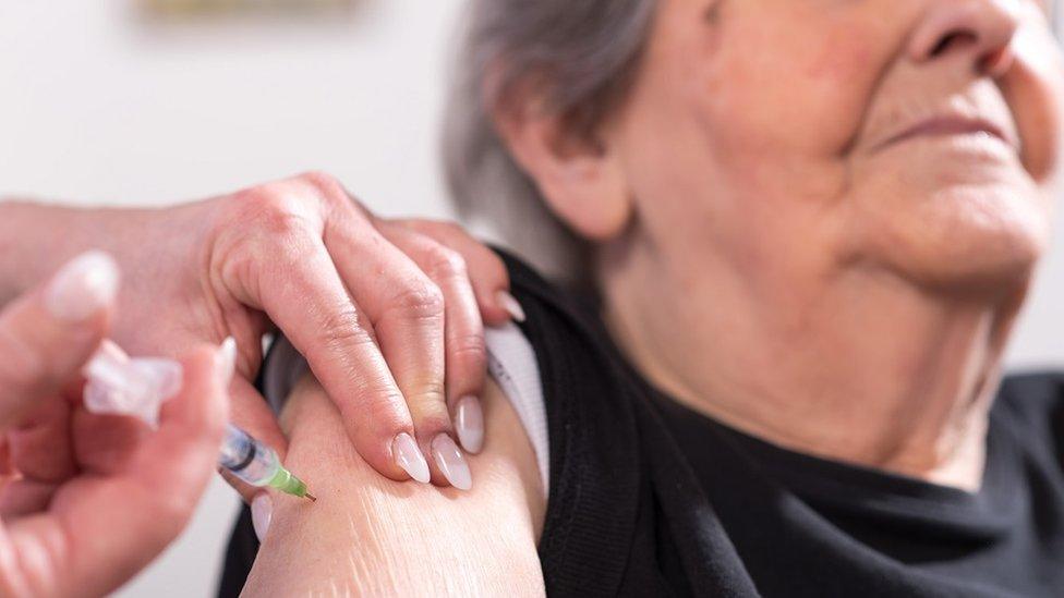 Older woman receiving injection