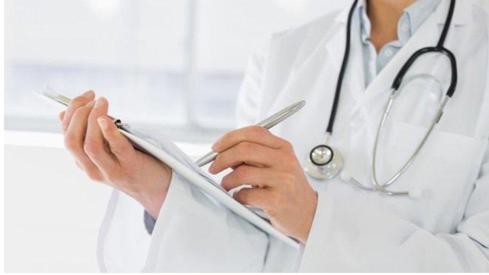 A doctor with a medical clipboard