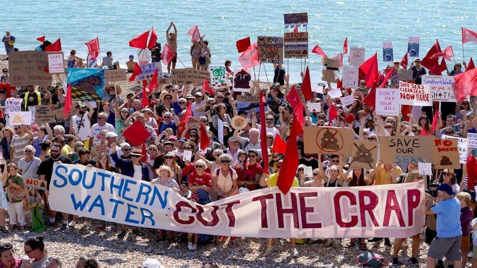 Protesters on a beach in St Leonards, Sussex, demonstrate against the release of raw sewage into the sea