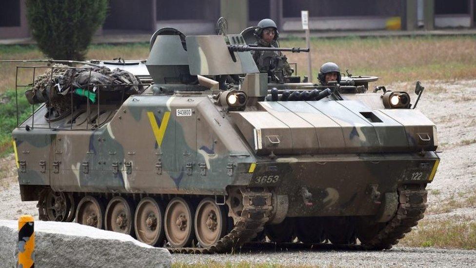 South Korean soldiers ride on an armoured vehicle during a South Korea-US combined arms collective training exercise at the US army's Rodriguez shooting range in Pocheon, about 70km north-east of Seoul (19 September 2017)