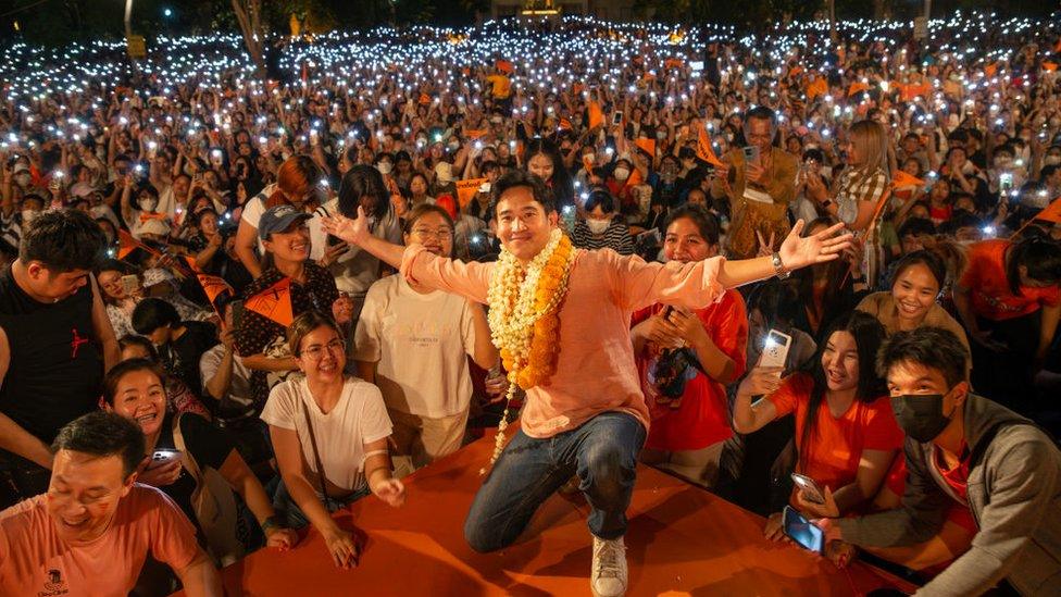 Leader of Move Forward Party Pita Limjaroenrat (C) poses for photos with his supporters during a general election campaign at Three Kings Monument in Chiang Mai.