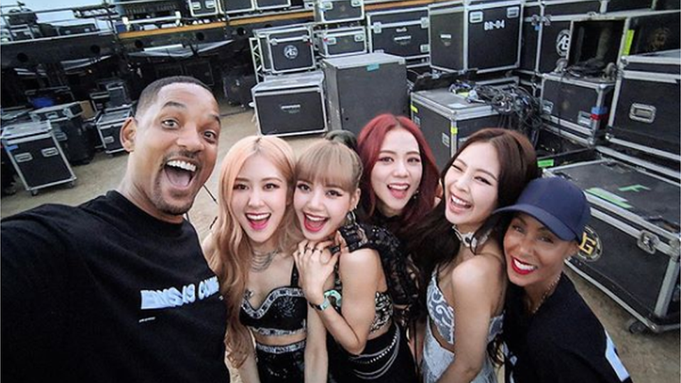 Will Smith and Jada Pinkett Smith pose for a photo with members of the band BlackPink