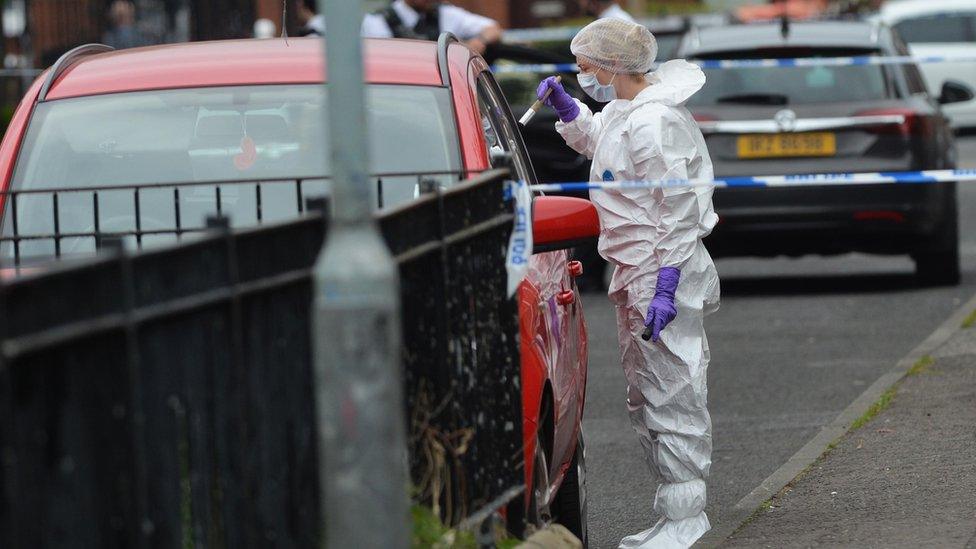 Forensic officers are carrying out investigations in the aftermath of the murder