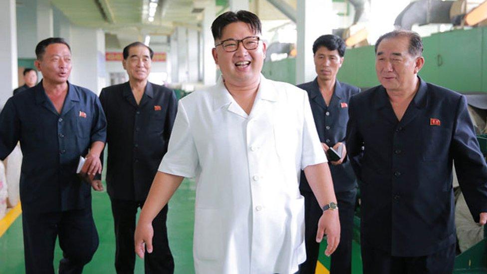 Kim Jong-un, seen at a recent factory visit looking at imitation leather products