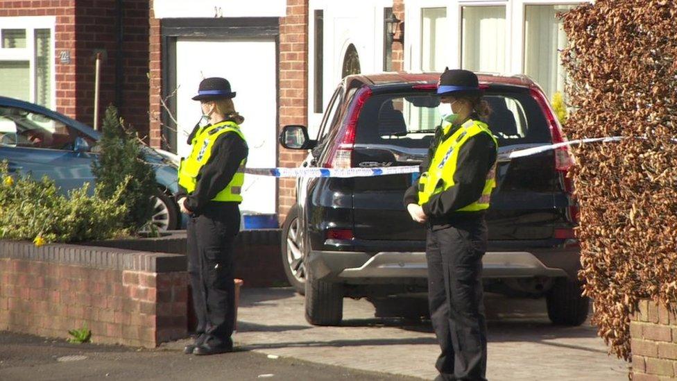 Police officers outside the house