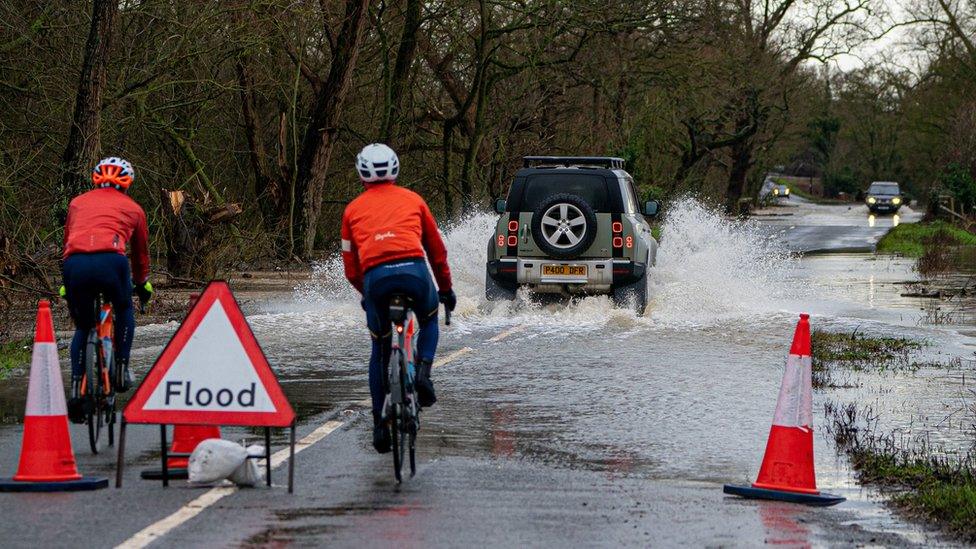 A vehicle is driven through floodwater at Apperley, Gloucestershire, where the River Severn burst it's banks and has flooded fields and roads across the county.