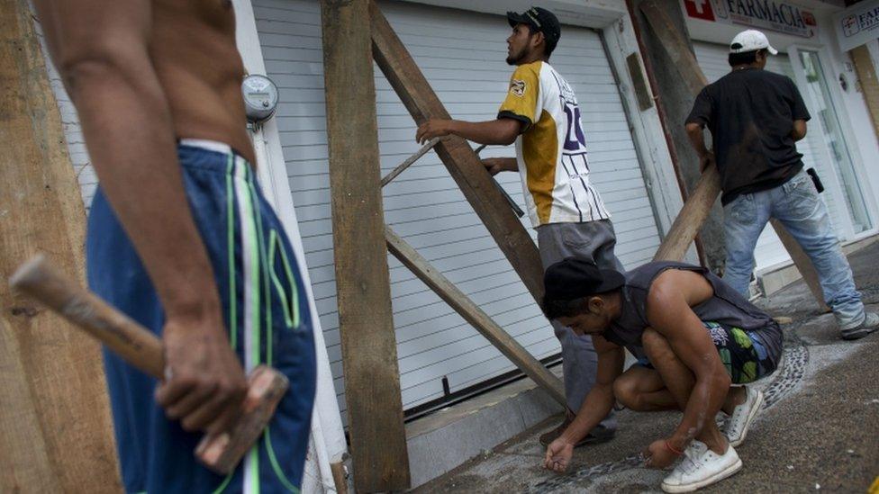 Men take down protective woodbeams in Mexico