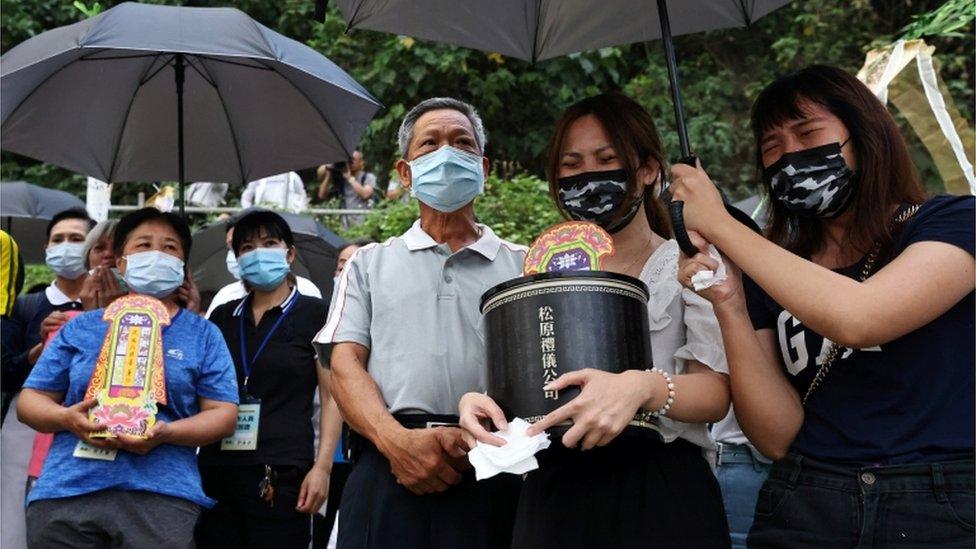 Relatives of train crash victims holding a memorial