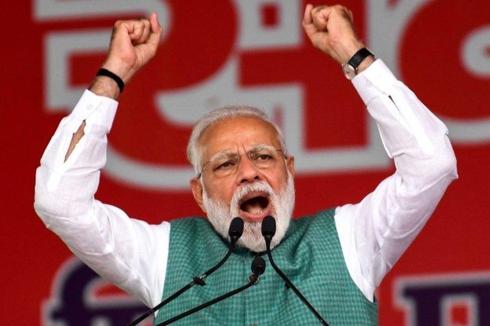 Indian Prime Minister Narendra Modi gestures as he speaks during the National Democratic Alliance (NDA) "Sankalp" rally in Patna in the Indian eastern state of Bihar on March 3, 2019.