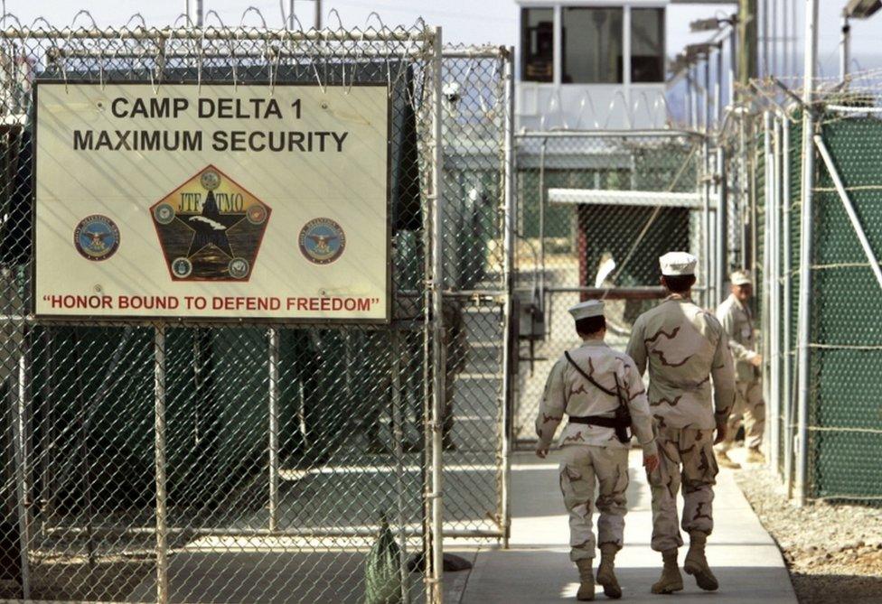 In this June 27, 2006 file photo, US military guards walk within Camp Delta military-run prison, at the Guantanamo Bay U.S. Naval Base, Cuba.