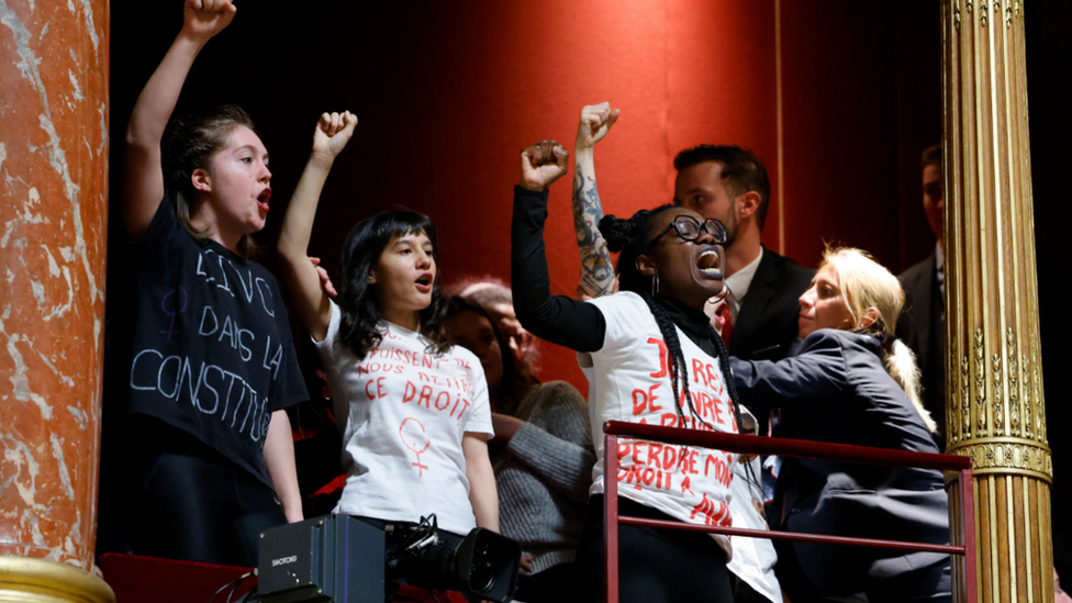 French protestors voiced their support for abortion rights from a balcony during a debate on a draft law on the constitutionalisation of the right to abortion at the Senate in Paris