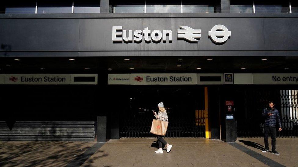 Pedestrians walk past London's Euston station