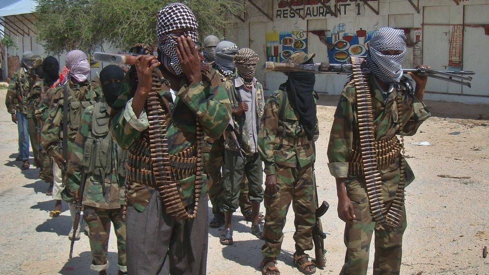 Al-Qaeda linked al-shabab recruits walk down a street on March 5, 2012 in the Deniile district of Somalian capital, Mogadishu, following their graduation