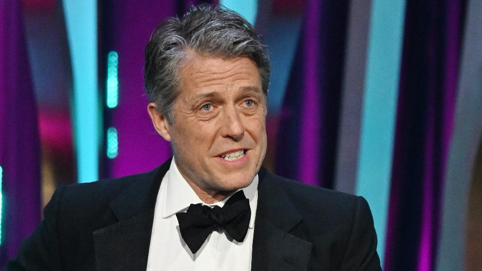 Hugh Grant onstage at the Bafta Film Awards