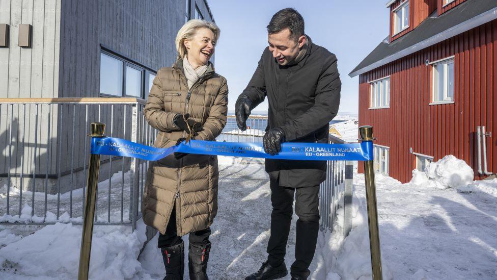 President of the European Commission Ursula von der Leyen and then Greenlandic Prime Minister Mute B Egede stand in the snow in big winter coats and gloves to cut the ribbon for the opening of the European Commission's new office in Nuuk, Greenland