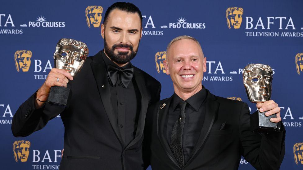 Rylan Clark and Robert Rinder pose with the Factual Entertainment Award for 'Rob and Rylan's Grand Tour' inside the Winners Room at the 2025 BAFTA Television Awards with P&O Cruises at The Royal Festival Hall on May 11, 2025 in London, England