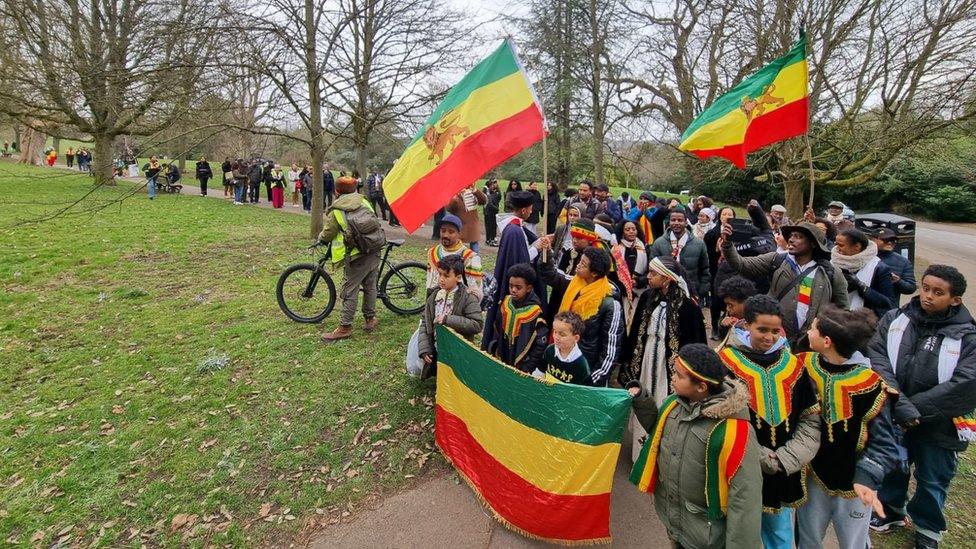 People walking through a park with Ethiopian flags