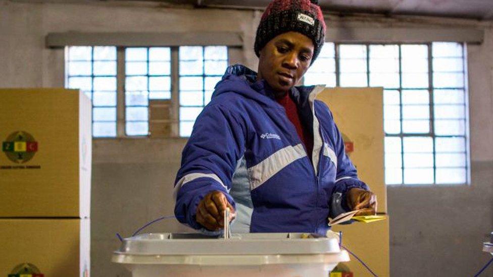 A woman casts her vote at Stanley Hall polling station in the township of Makokoba on July 30, 2018