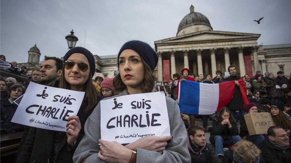 People in Trafalgar Square gather to pay their respects to the victims of the Charlie Hebdo attacks