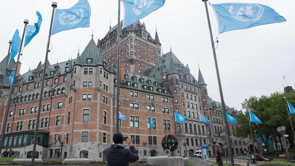 UN flags fly in front of the Fairmont Le Chateau Frontenac