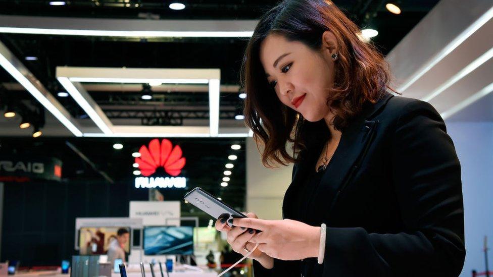 Woman looking at Huawei phone