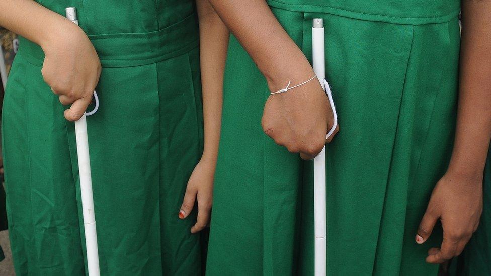 Two school girls with white canes